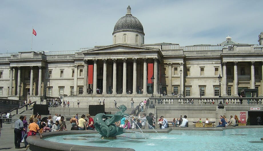 Dome building of the National Gallery of London with Trafalgar Square fountain in foreground