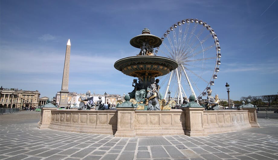 Fountain in front of Ferris Wheel and Obelisk on the Place de la Concorde in Paris, France.