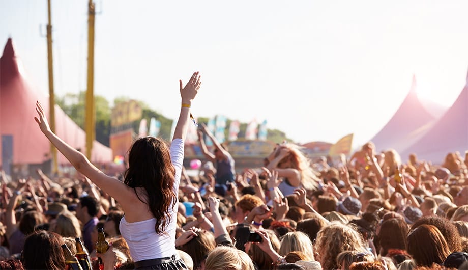 Girl dancing in crowd at popular music festival in Europe