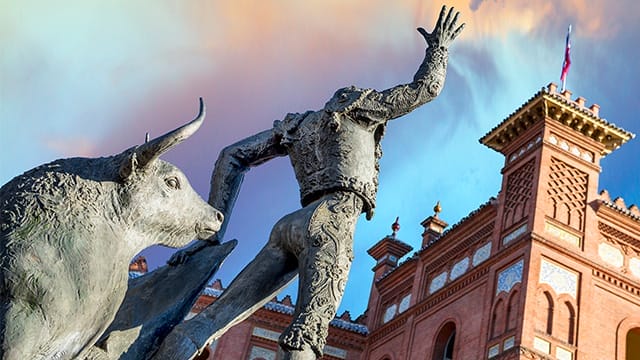 statue of a bullfighter and bull outside an arena in madrid, spain