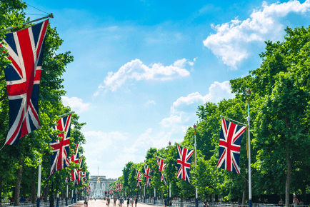 british union jack flags outside buckingham palace in london, england