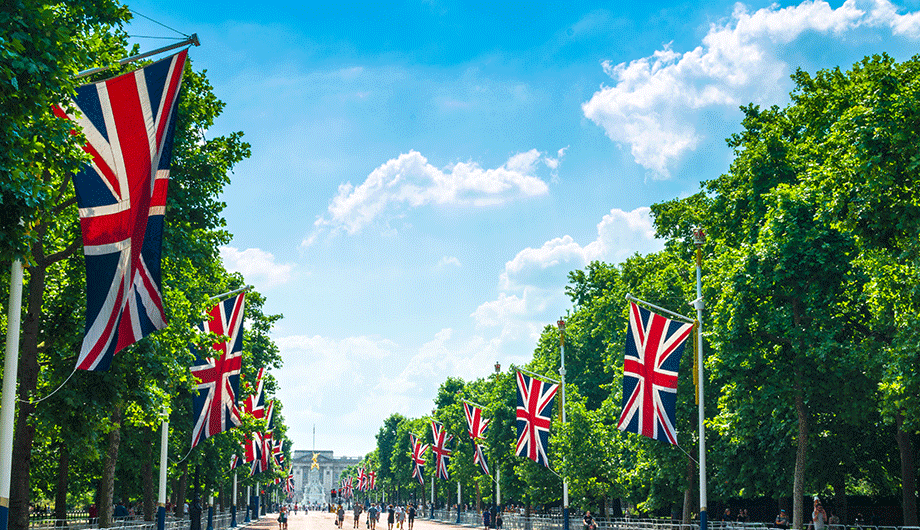 british union jack flags outside buckingham palace in london, england