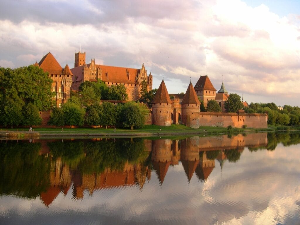 Malbork Castle walls in front of water in Poland.