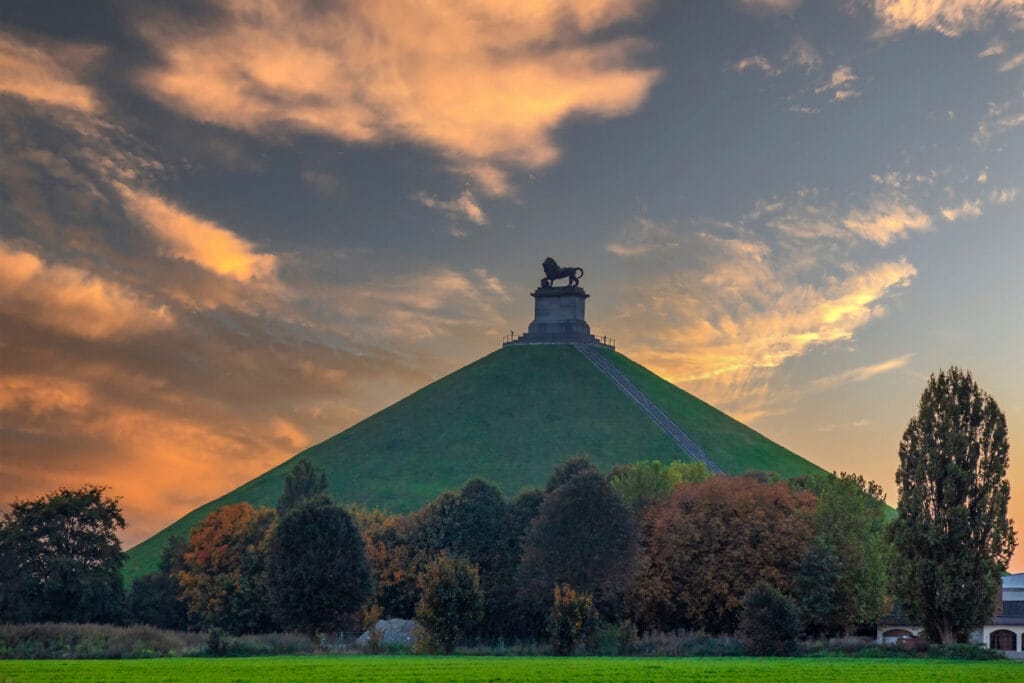 Famous Lion's Mound (Butte du Lion), a conical artificial hill located in the municipality of Braine-l'Alleud commemorating the battle of Waterloo, on a moody day with dark clouds in summer, Belgium