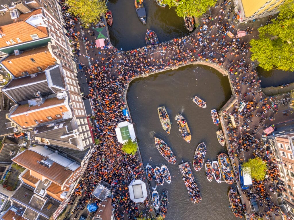 Canal boat parade on Koningsdag Kings day festivities in Amsterdam. Birthday of the king. 